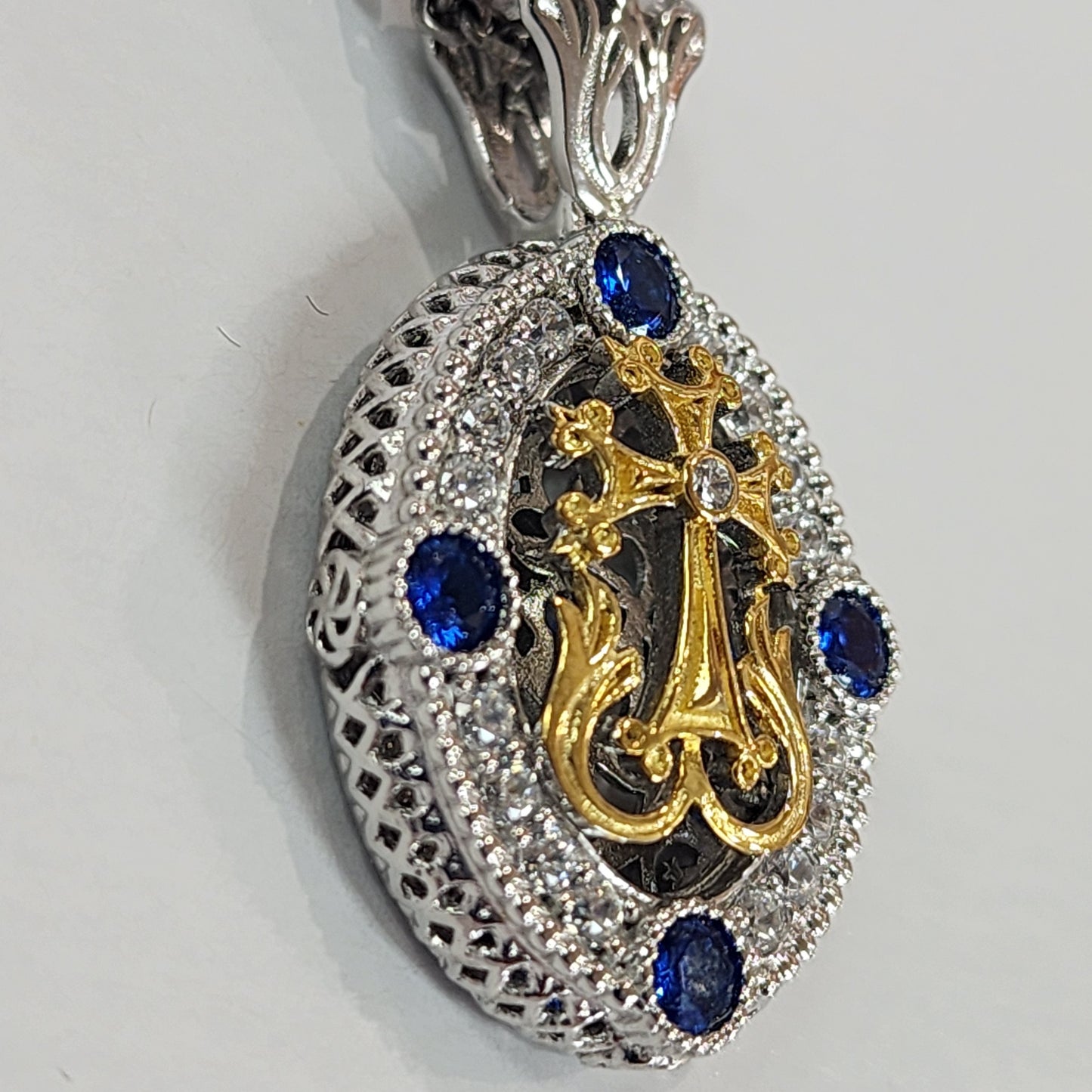 "Talar" Oval blue stone cross pendant